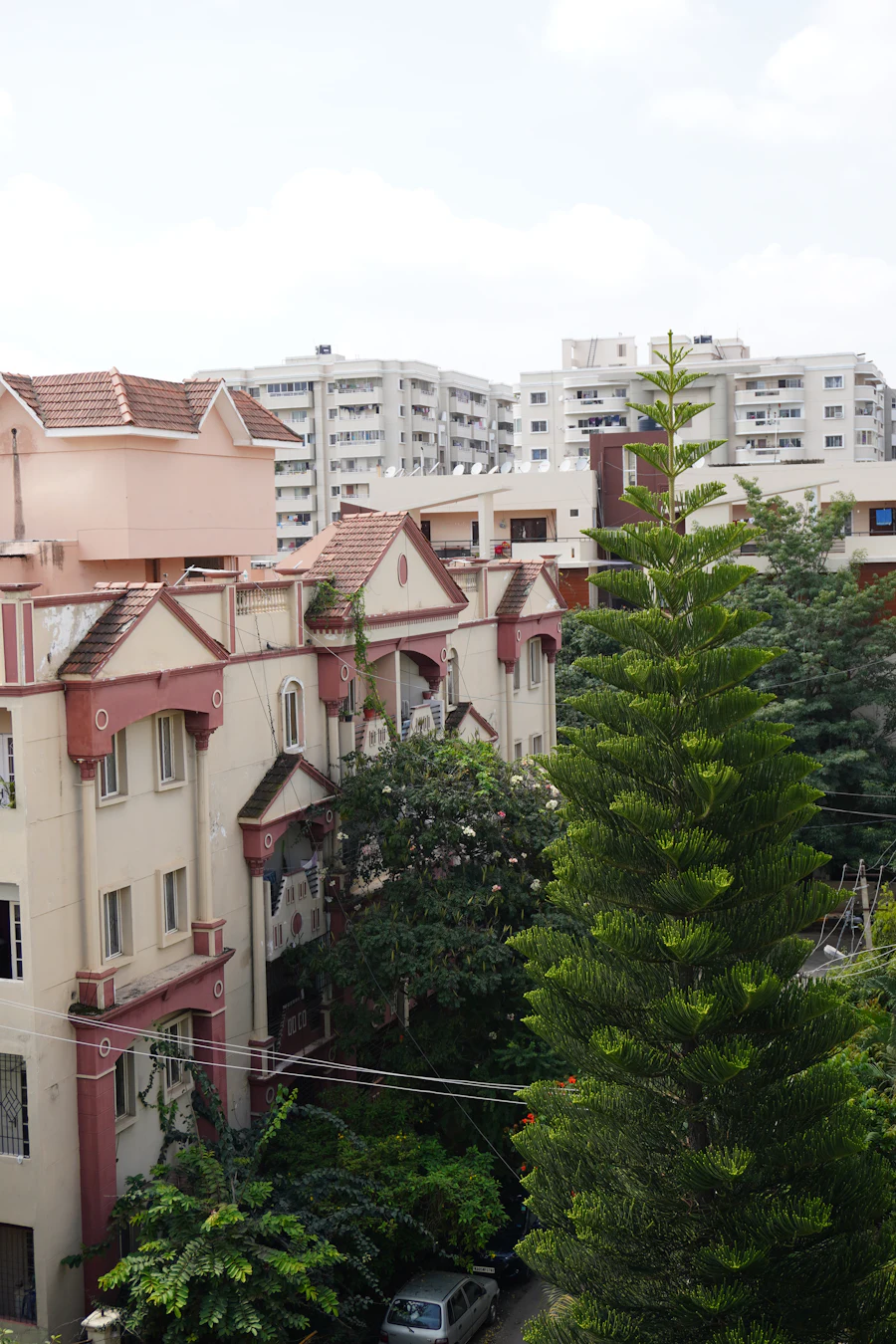 A residential neighbourhood of low-rise apartment blocks and independent houses among trees